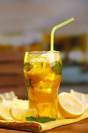 Iced tea with lemon and mint on wooden table, outdoorsの写真素材