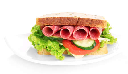 Tasty sandwich with salami sausage and vegetables on white plate, isolated on whiteの写真素材