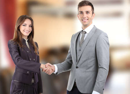 Business colleagues shaking hands at officeの写真素材