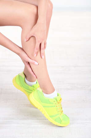 Girl with sore foot isolated on whiteの写真素材