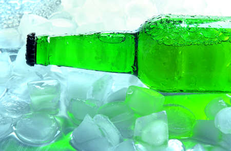 Bottle of beer with ice cubes, close upの写真素材