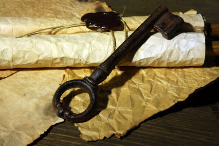 Antique key and scroll on dark backgroundの写真素材