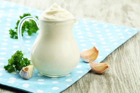 Sour cream in pitcher on table close-upの写真素材