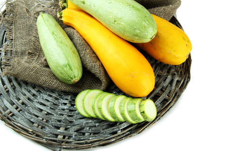 Sliced and whole raw zucchini, isolated on whiteの写真素材