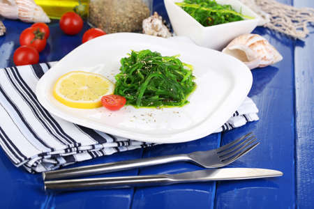 Sea kale on plate on wooden table close-up の写真素材