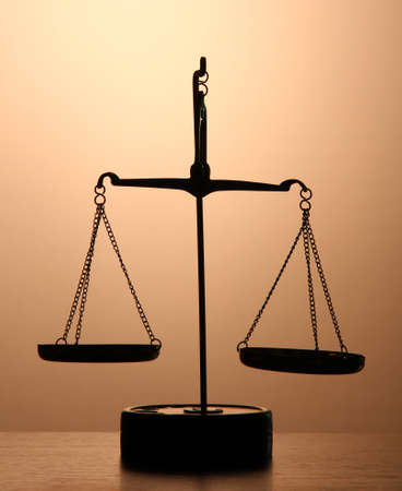 Gold scales of justice on brown backgroundの写真素材