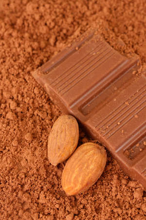 Chopped chocolate with cocoa, on brown backgroundの写真素材