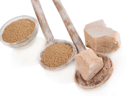 Dry yeast in spoons isolated on whiteの写真素材