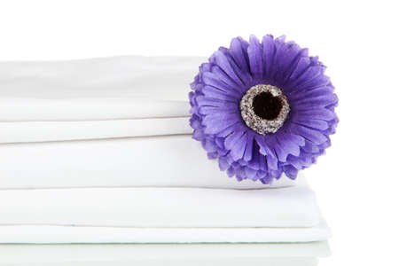 Stack of clean bedding sheets isolated on whiteの写真素材