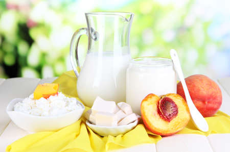 Fresh dairy products with peaches on wooden table の写真素材