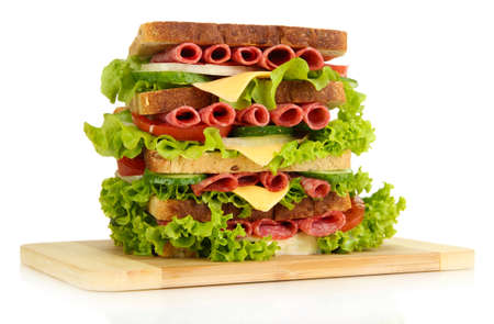 Huge sandwich on wooden board, isolated on whiteの写真素材