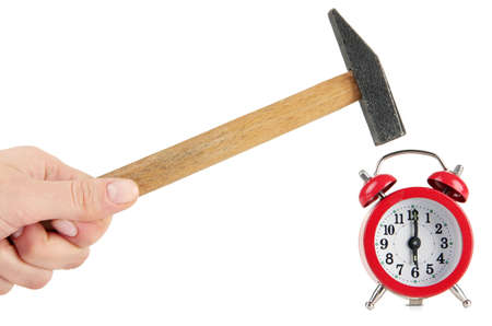 Hammer in hand and alarm clock isolated on whiteの写真素材