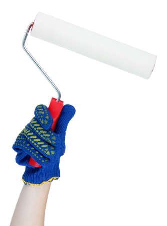 Bright paint roller in hand isolated on whiteの写真素材