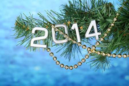 2014 hang on Christmas tree close-up on blue backgroundの写真素材