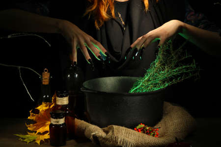  Witch in scary Halloween laboratory on dark color backgroundの写真素材