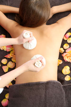 Beautiful young woman having back massage close upの写真素材