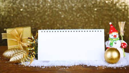 Empty calendar, New Year decor and fir tree on shiny golden backgroundの写真素材