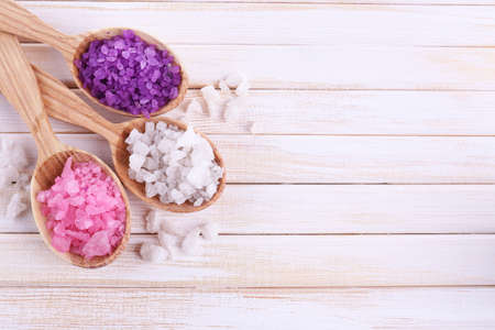 Wooden spoons with sea salt, on color wooden backgroundの写真素材