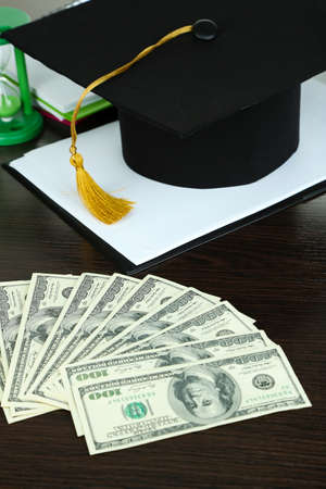 Money for graduation or training on wooden table close-upの写真素材