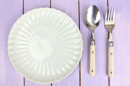 Plate and cutlery on wooden table close-upの写真素材