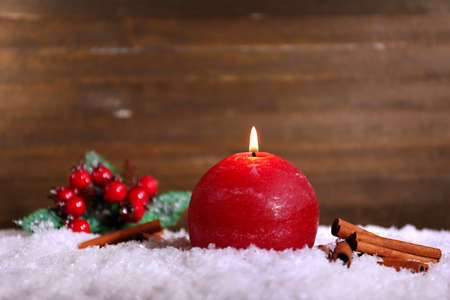 Burning candle on wooden backgroundの写真素材