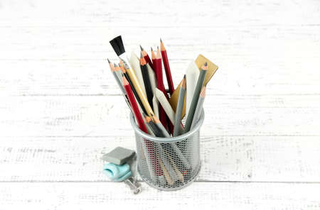 Professional art materials in metal holder, on wooden tableの写真素材