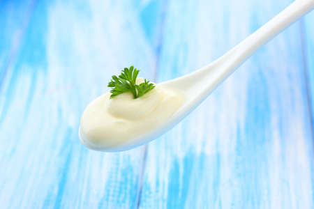 Sour cream in spoon close-upの写真素材