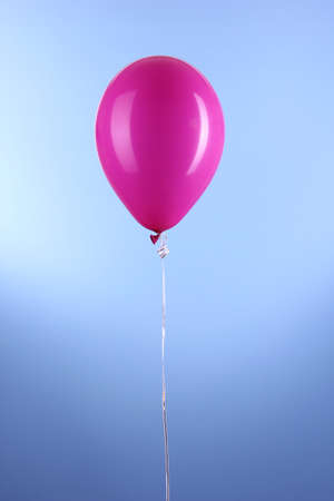 Purple one balloon on blue backgroundの写真素材