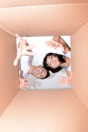 Young couple unpacking boxの写真素材