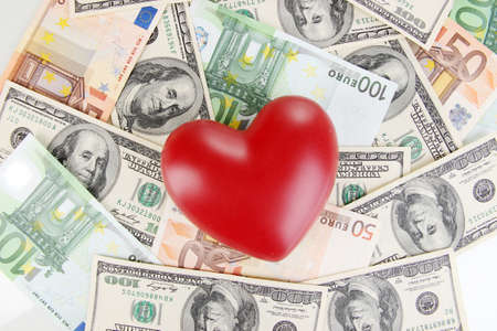Love and money concept. Heart on European and American moneyの写真素材