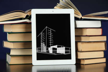 Tablet with house sketch project and booksの写真素材