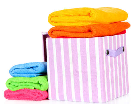 Textile box with bright towels, isolated on whiteの写真素材