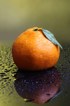 Ripe sweet tangerine, on dark color backgroundの写真素材