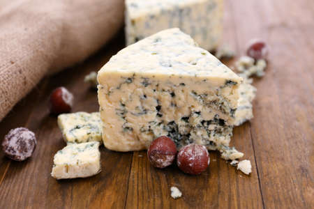 Tasty blue cheese with nuts, on wooden tableの写真素材