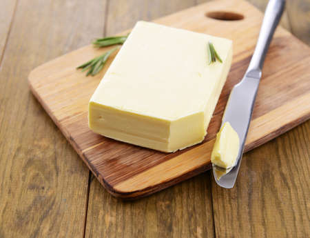 Tasty butter on wooden cutting board の写真素材