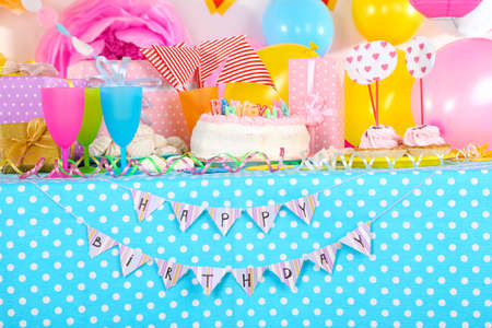 Festive table setting for birthday on celebratory decorations の写真素材
