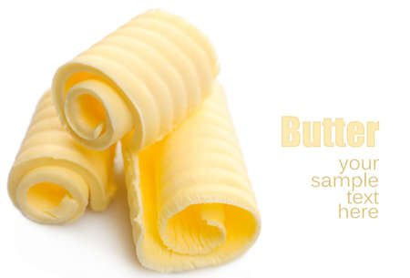 Curls of fresh butter, isolated on whiteの写真素材