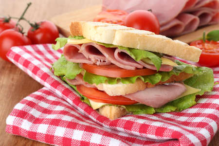 Tasty sandwich with ham on wooden tableの写真素材