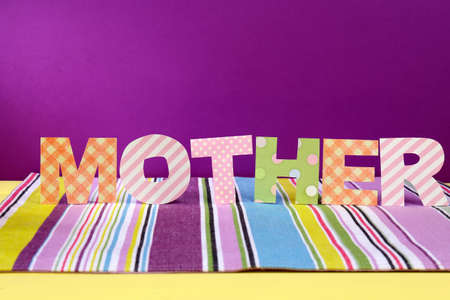 Mother- lettering of handmade paper letters on purple backgroundの写真素材
