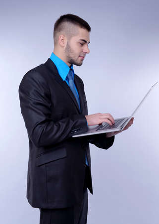Business man on grey backgroundの写真素材
