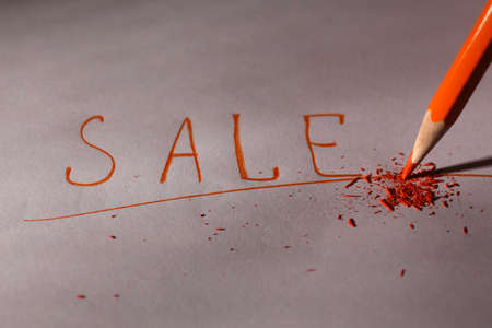 Word Sale and breaking pencil on paper, close upの写真素材