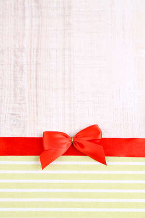 Colorful fabric with color ribbon and bow on wooden backgroundの写真素材