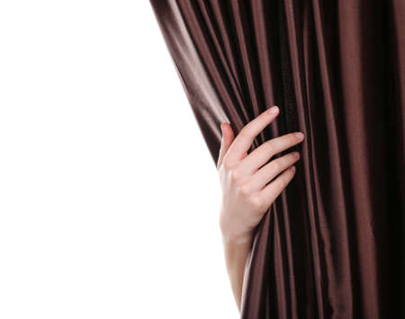 Hand opening curtain isolated on white の写真素材