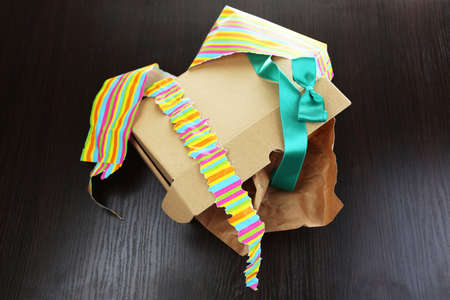Unwrapped and opened gift box  on wooden backgroundの写真素材