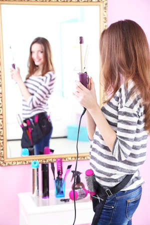 Beautiful girl hairdresser in beauty salonの写真素材