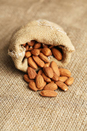 Almonds in sack on on sackcloth backgroundの写真素材