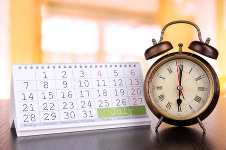 Alarm clock  and calendar on bright backgroundの写真素材