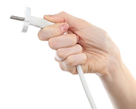 Hand holding electric plug isolated on white の写真素材