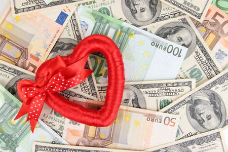 Love and money concept. Heart on European and American moneyの写真素材