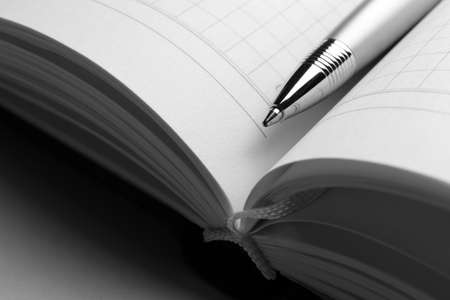 Pen on opened book on grey table, close upの写真素材